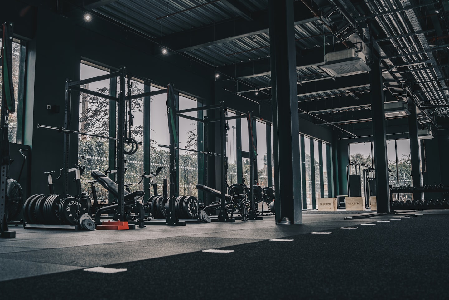 Modern gym with weight racks and natural light.